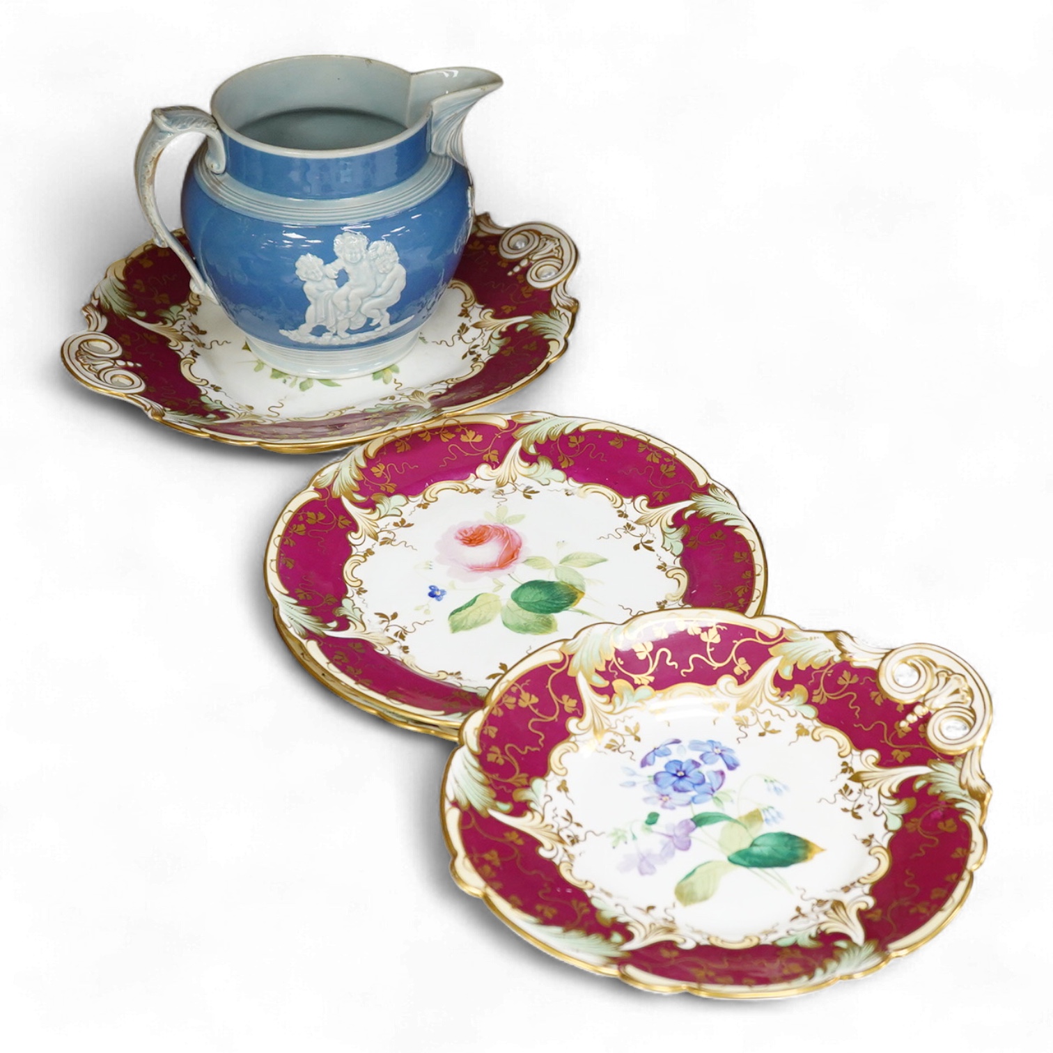 An early 19th century pearlware sprigged jug and four mid 19th century Ridgway flower painted dessert plates